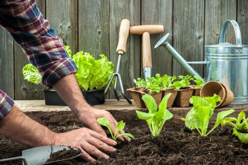 Gardener preparing eco-friendly garden maintenance in East Ham with tools and sacks