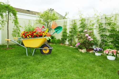 Garden clearance crew removing debris from a small terraced backyard